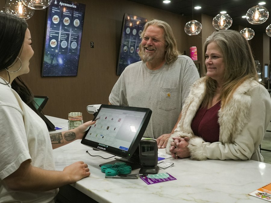 Customers paying at a store counter
